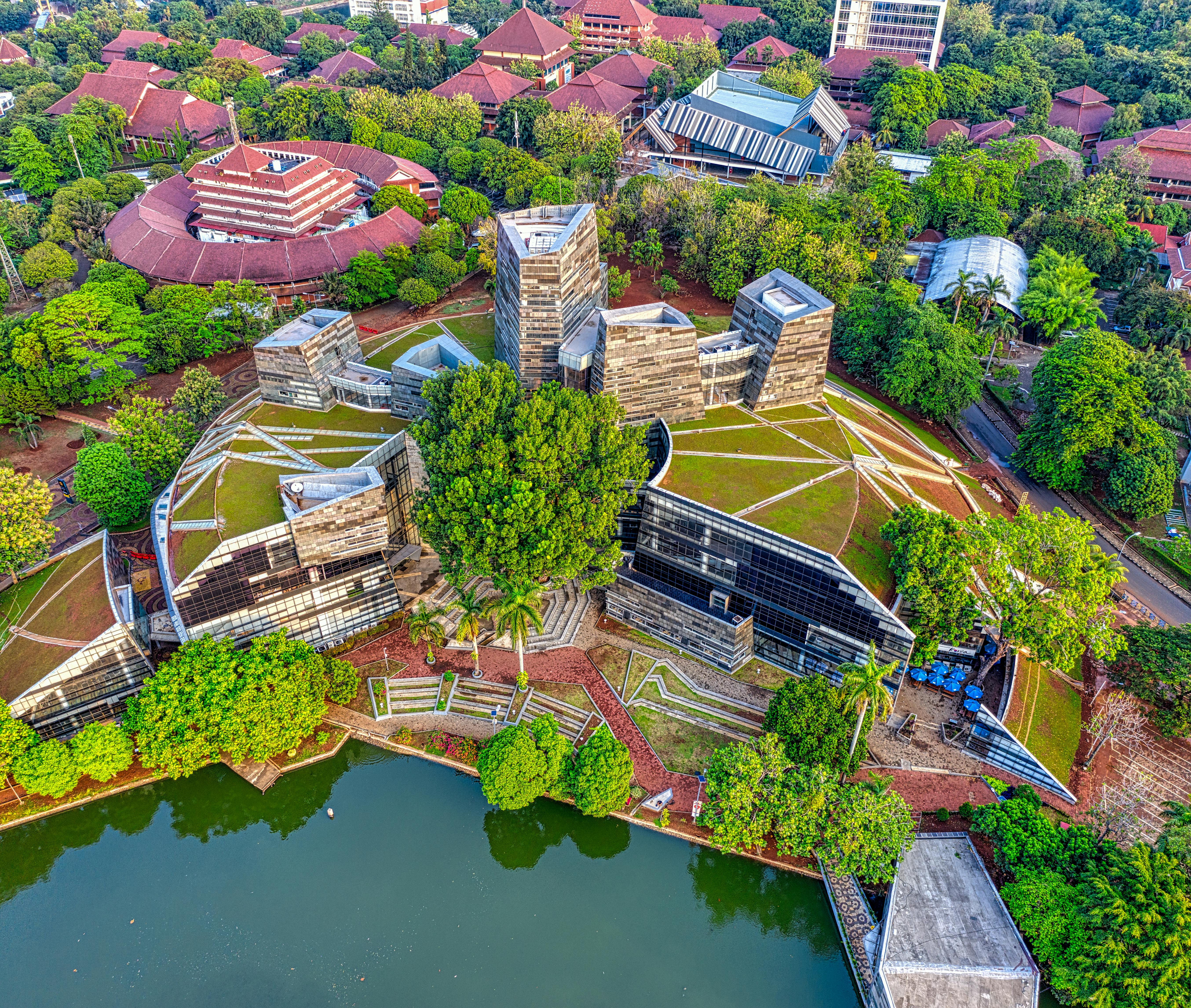 Aerial shot showcasing unique architectural design surrounded by lush greenery in West Java, Indonesia.